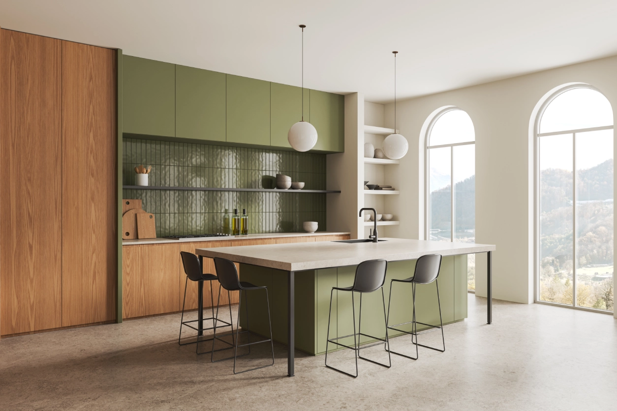 Modern kitchen with green cabinets and island.